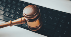 Embedded image of a judge’s gavel hovering over a computer keyboard