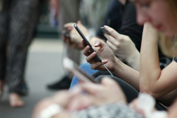 [Embedded image of a person holding up a smartphone]